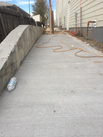 sustainable design build denver colorado west colfax 1220 perry during construction sidewalk retaining wall concrete flatwork