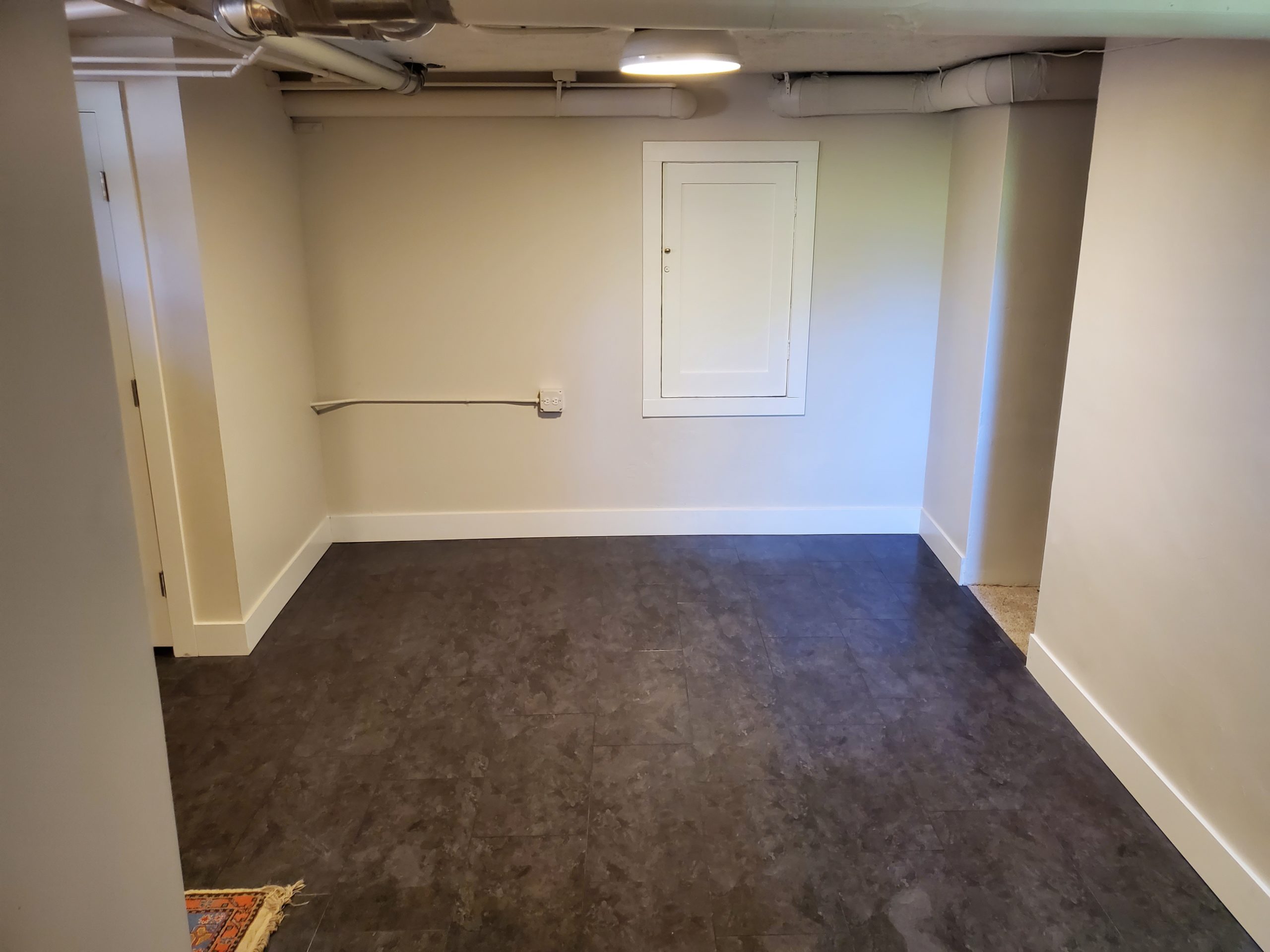 Bellaire Street remodel project completed denver hardwood vinyl plank tile trim white black grey drywall 