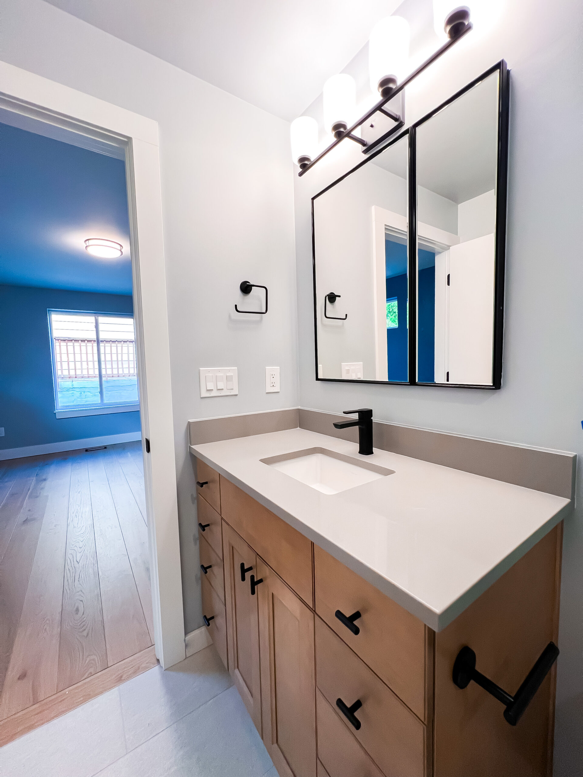 Montclair Home Addition Sustainable Design Build Denver Custom Home Builder Remodeling Company Bathroom Remodel Mirror Vanity Light Bar
