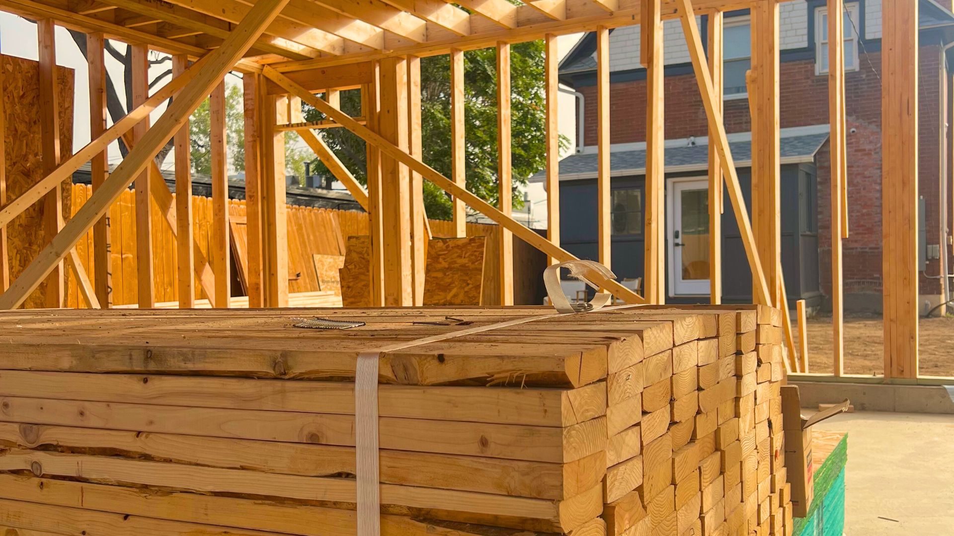 How New Trade Policies Could Shape Wood Prices and Home Construction in 2025 How New Trade Policies Could Shape Wood Prices and Home Construction in 2025 Denver Home Construction showing a lumber pile during rough framing of a custom home project