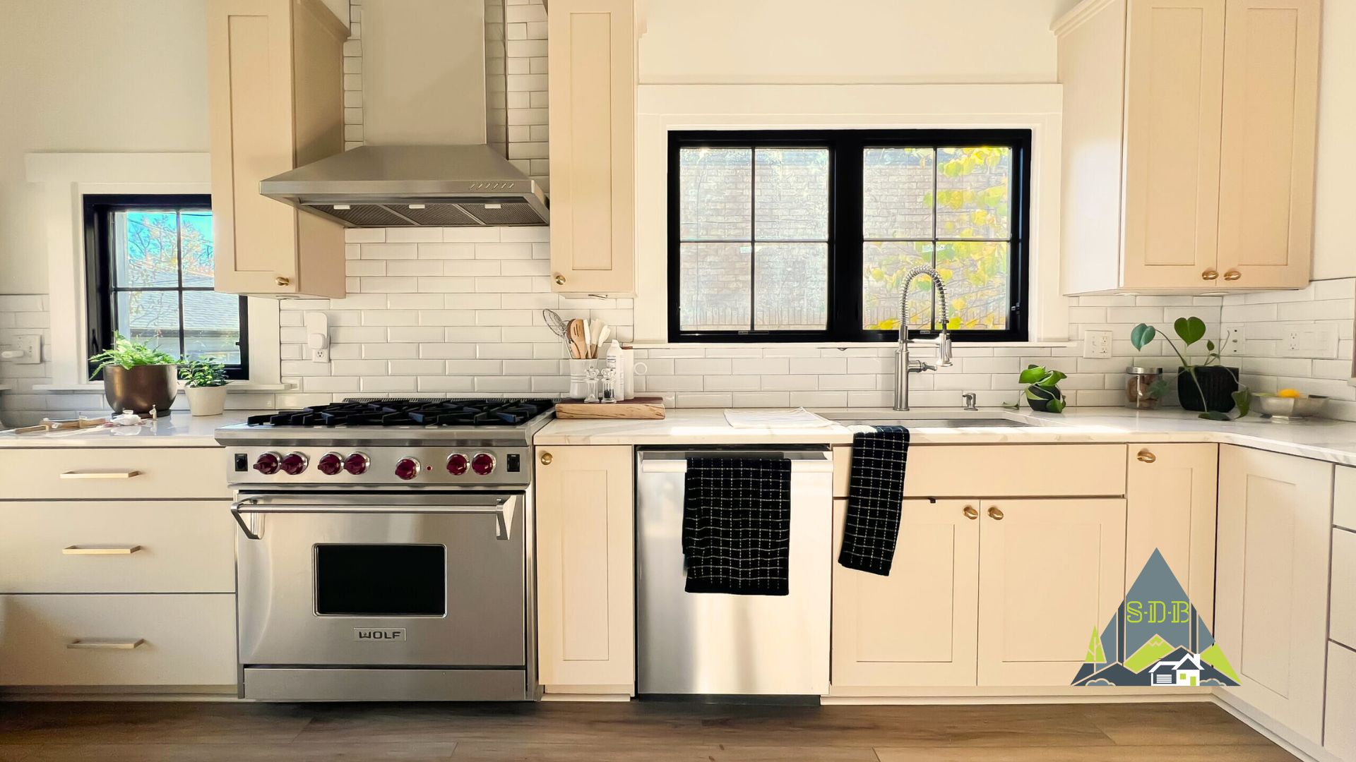 Sustainable Design Build Custom cabinetry in a home addition and remodel project located in denver. Well lit and natural lighting for a kitchen in stainless steel appliances and white custom cabinets