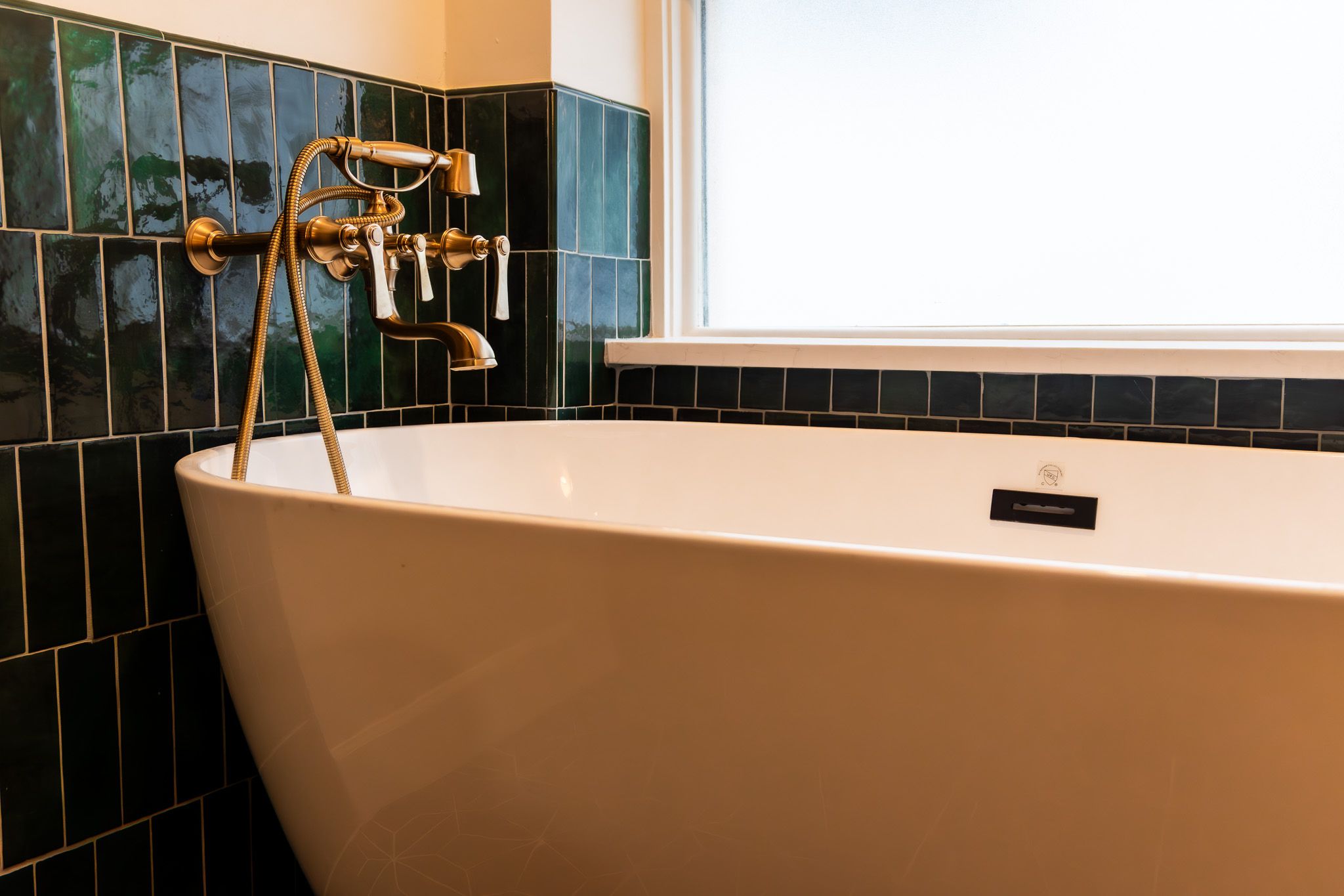 Bathroom remodel green emerald tile white porcelain tub free standing tub gold bathroom hardware and faucet