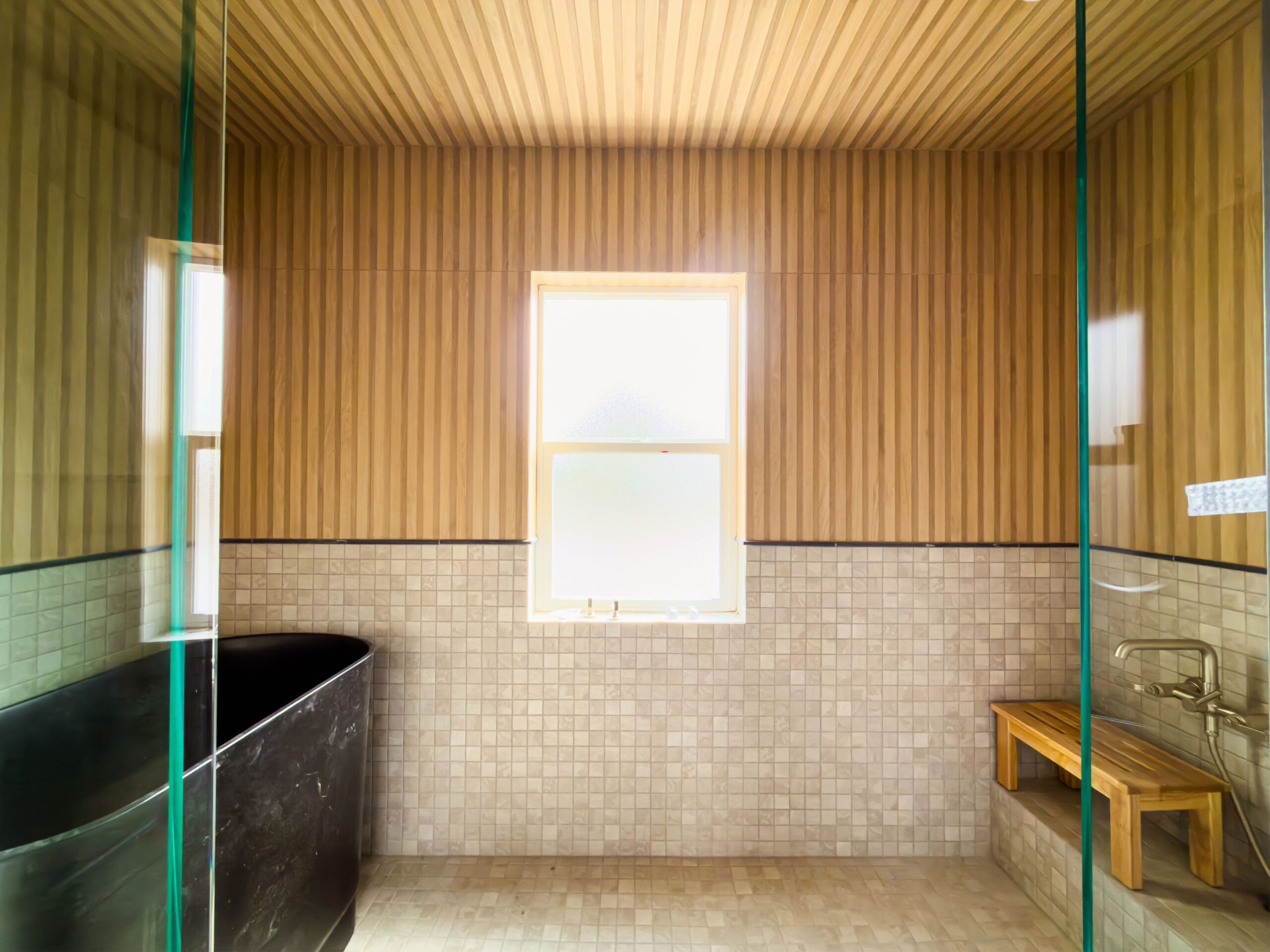 japanese style bathroom remodel wood walls tiled floor free standing tub shower curb