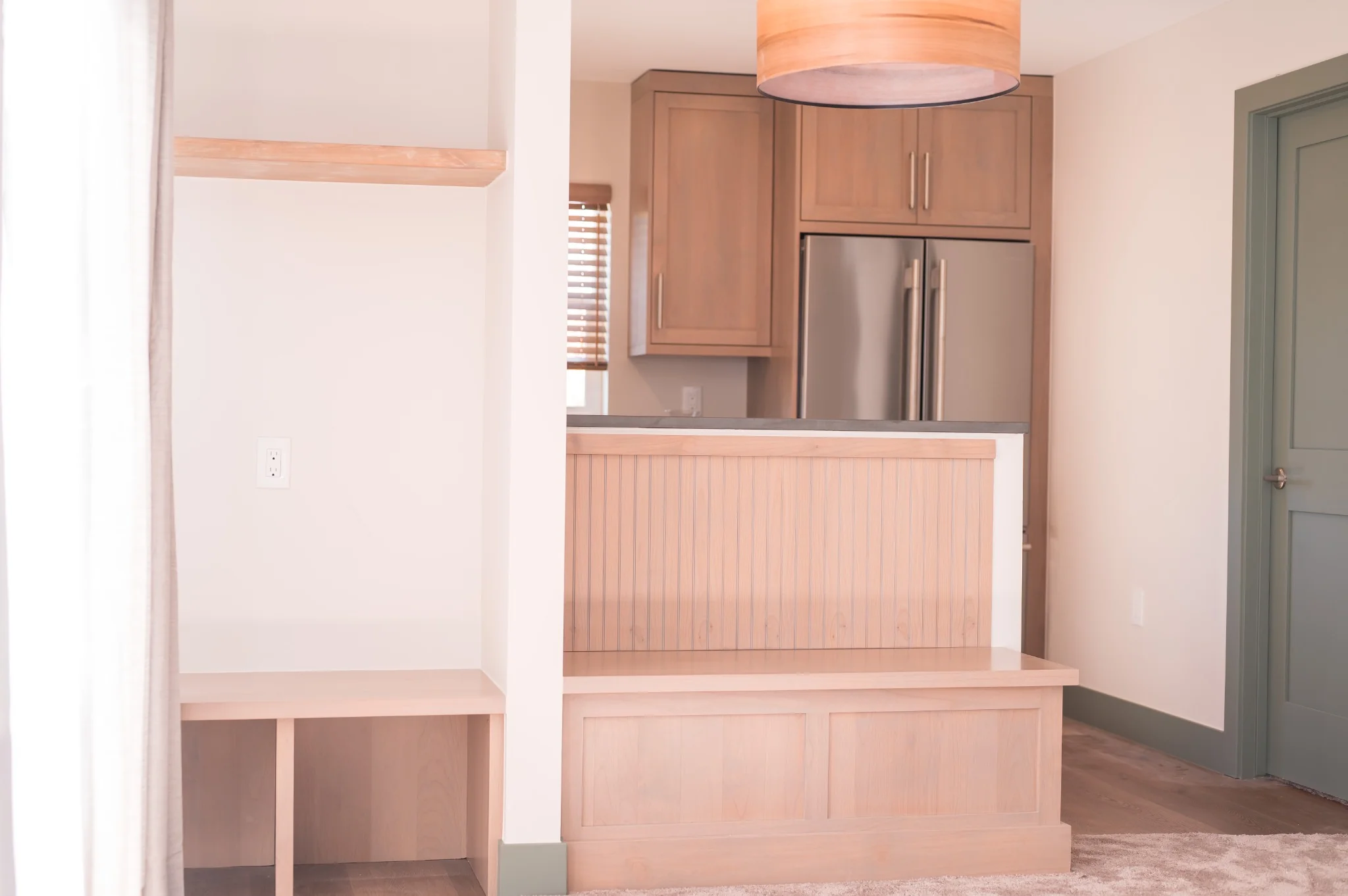 Denver ADU living room and entrance bright warm and airy soft wood tones paneling modern finishes